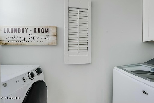 clothes washing area featuring washer and dryer and laundry area