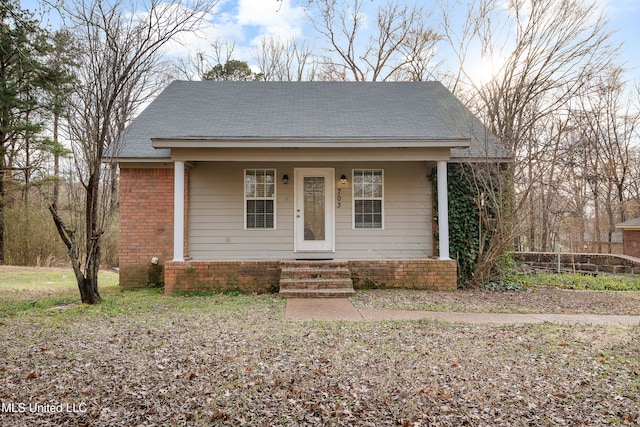 bungalow-style house featuring brick siding and a porch