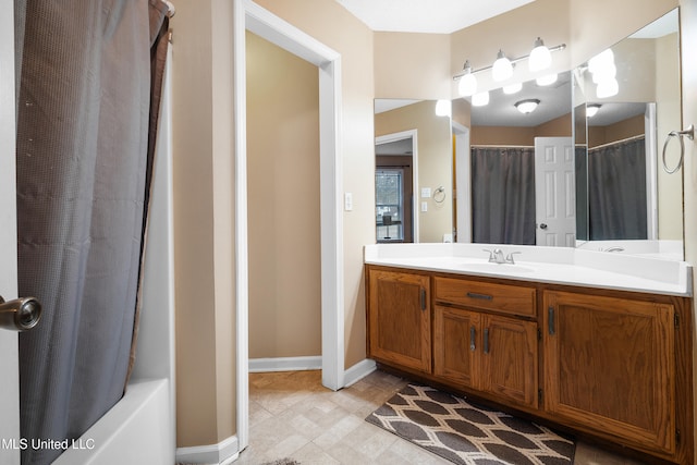 full bathroom with baseboards and vanity