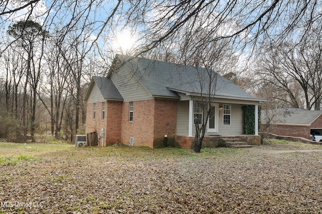 view of front of home with a porch and brick siding