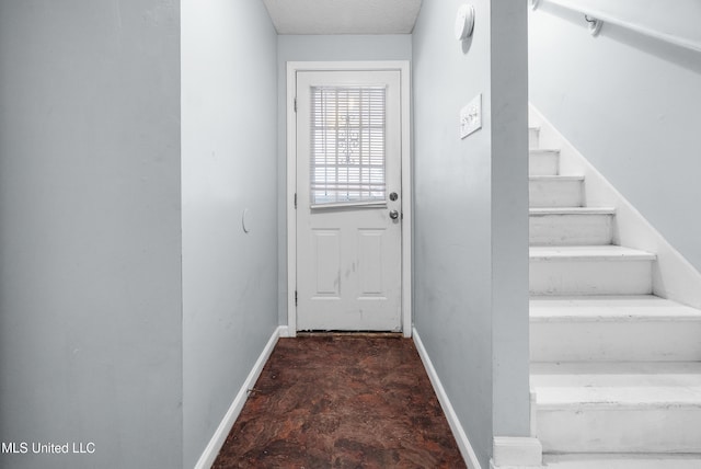 doorway with baseboards and stairs