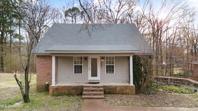 view of front facade with a porch and brick siding