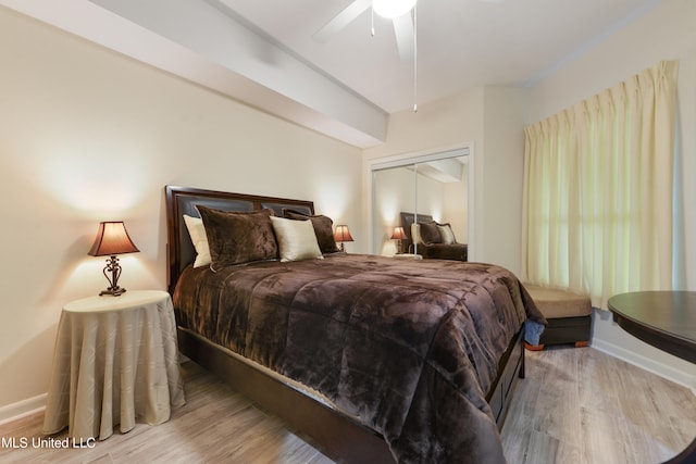 bedroom with a closet, ceiling fan, and light hardwood / wood-style flooring