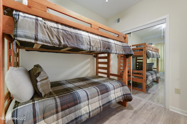 bedroom featuring a closet and light hardwood / wood-style flooring