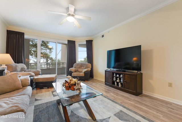 living room with light hardwood / wood-style floors, ceiling fan, and ornamental molding