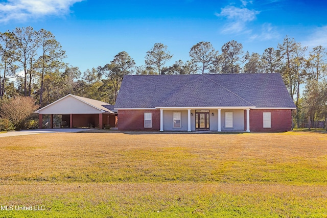 single story home with a porch, a front yard, and a carport