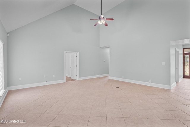 unfurnished living room featuring light tile patterned floors and high vaulted ceiling