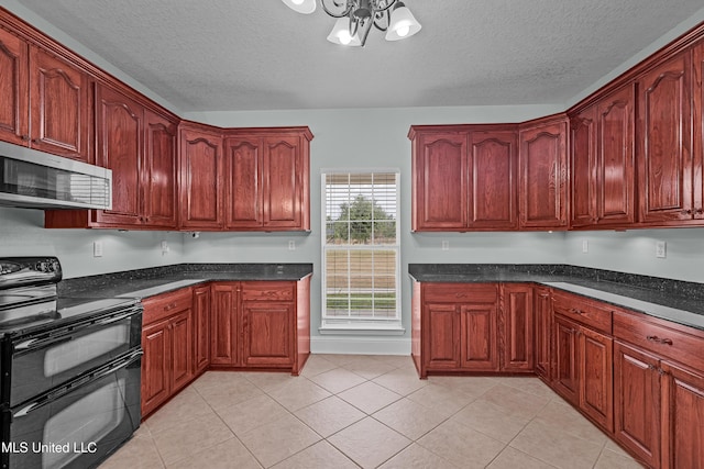 kitchen featuring dark stone counters, a textured ceiling, light tile patterned floors, electric range, and an inviting chandelier