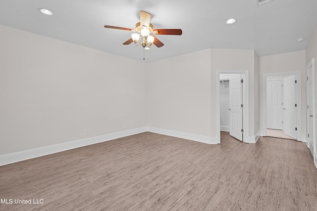 unfurnished room with ceiling fan and light hardwood / wood-style flooring