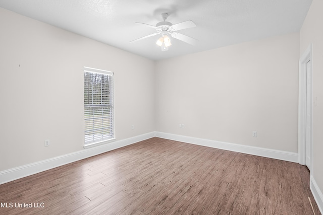 empty room with ceiling fan and wood-type flooring