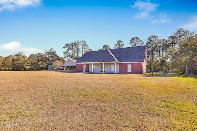 ranch-style house with a front lawn and covered porch