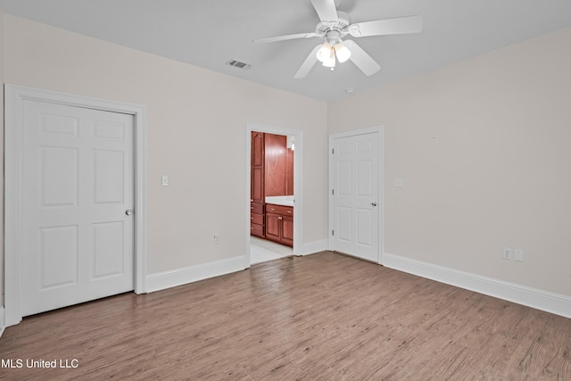 unfurnished bedroom featuring ceiling fan, light wood-type flooring, and ensuite bathroom