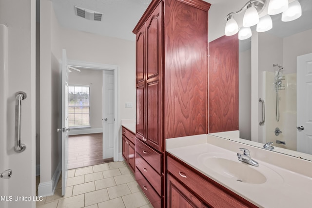 bathroom featuring tile patterned flooring, vanity, and shower / washtub combination