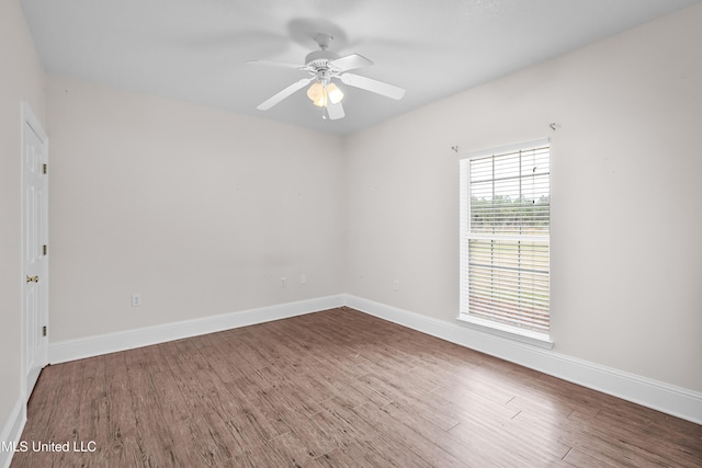 empty room with ceiling fan and wood-type flooring