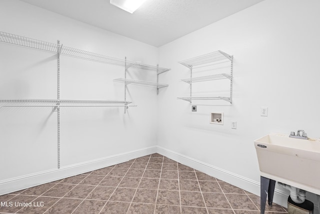 washroom featuring hookup for an electric dryer, hookup for a washing machine, tile patterned floors, a textured ceiling, and sink