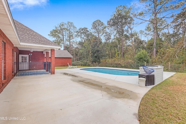 view of swimming pool featuring ceiling fan and a patio