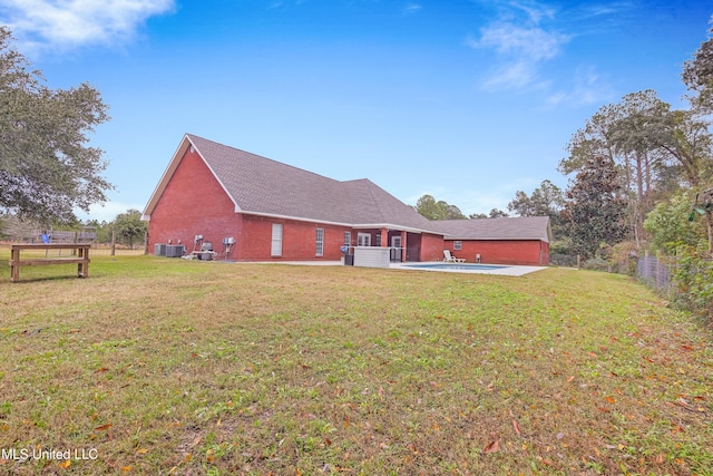 rear view of property with a lawn and a patio area