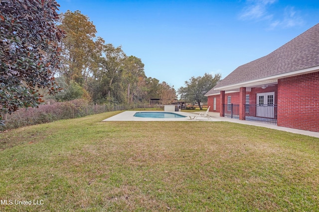 view of yard featuring a fenced in pool and a patio