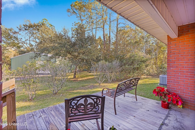 wooden deck with a yard and cooling unit