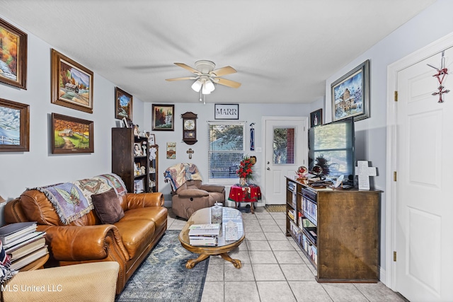 living room featuring ceiling fan and light tile patterned floors