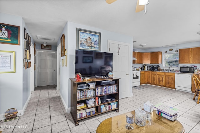 kitchen with ceiling fan, sink, light tile patterned floors, and white appliances