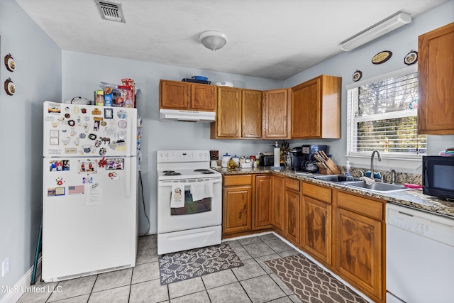 kitchen featuring white appliances, sink, and light tile patterned floors