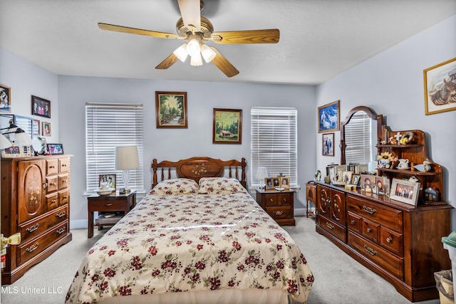 bedroom featuring ceiling fan and light carpet