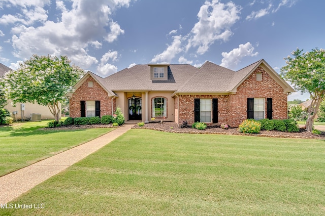 718 Tortoise Rdg, Brandon, MS 39047 - view of front of house featuring brick siding, a front yard, a shingled roof, and central AC