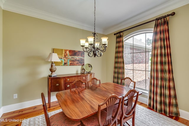 718 Tortoise Rdg, Brandon, MS 39047 - dining area featuring crown molding, a chandelier, wood finished floors, and baseboards