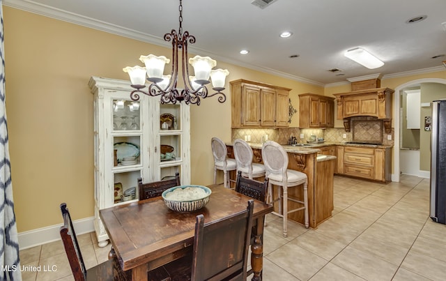 718 Tortoise Rdg, Brandon, MS 39047 - dining space featuring arched walkways, light tile patterned floors, ornamental molding, a chandelier, and baseboards