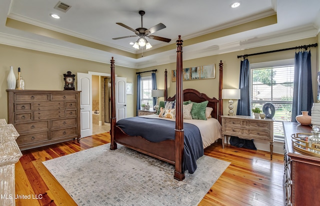 718 Tortoise Rdg, Brandon, MS 39047 - bedroom featuring a raised ceiling, multiple windows, light wood finished floors, ornamental molding, and recessed lighting