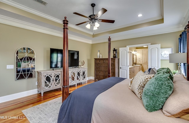 718 Tortoise Rdg, Brandon, MS 39047 - bedroom with baseboards, wood finished floors, crown molding, a tray ceiling, and ceiling fan