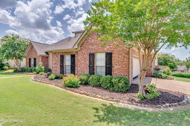 718 Tortoise Rdg, Brandon, MS 39047 - view of front of property featuring brick siding, driveway, a front yard, a shingled roof, and an attached garage
