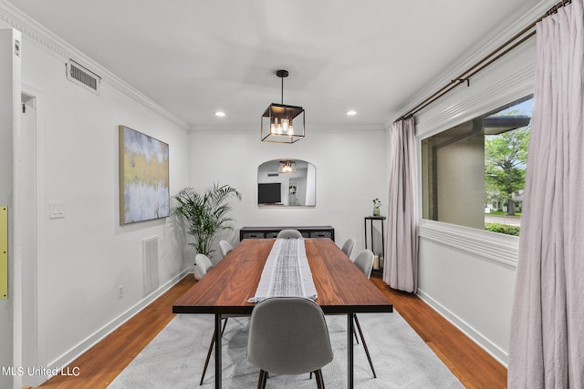 dining room featuring ornamental molding and hardwood / wood-style flooring