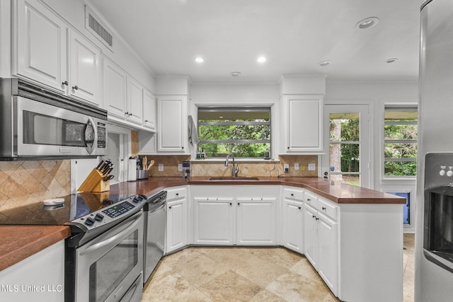 kitchen with sink, white cabinetry, and stainless steel appliances