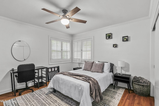 bedroom with crown molding, dark hardwood / wood-style floors, and ceiling fan