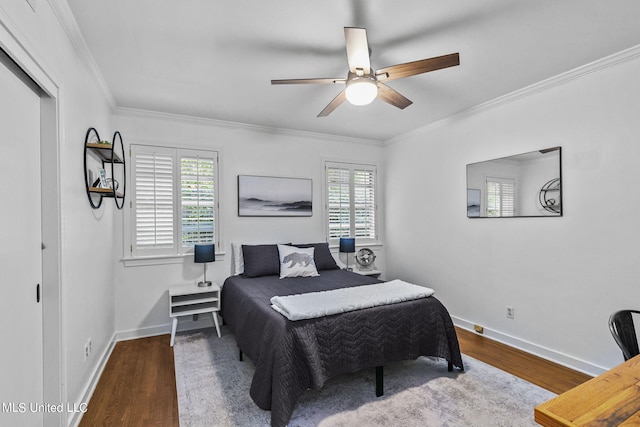 bedroom with ornamental molding, multiple windows, wood-type flooring, and ceiling fan