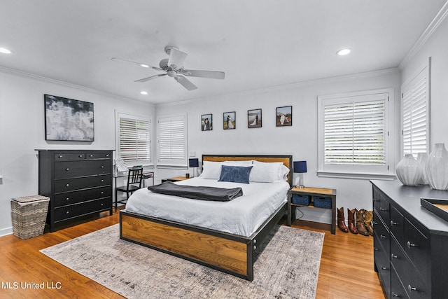 bedroom with ceiling fan, crown molding, and light hardwood / wood-style flooring