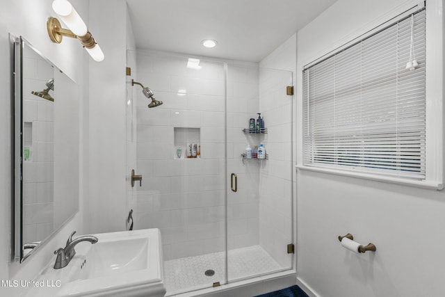 bathroom with an enclosed shower and sink