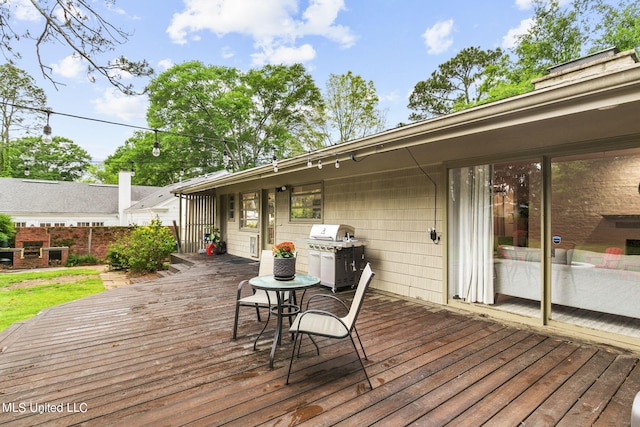 wooden deck featuring area for grilling