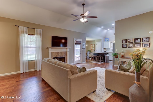 2634 Harvest Tree Dr, Southaven, MS 38672 - living room with plenty of natural light, a tiled fireplace, ceiling fan, lofted ceiling, and dark wood-style floors