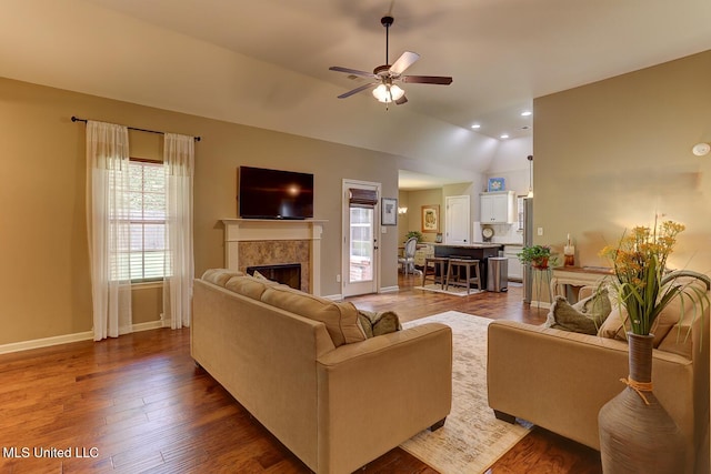 2634 Harvest Tree Dr, Southaven, MS 38672 - living area featuring healthy amount of natural light, a tile fireplace, a ceiling fan, lofted ceiling, and wood finished floors