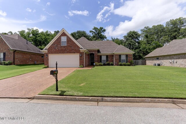 2634 Harvest Tree Dr, Southaven, MS 38672 - traditional-style house with driveway, brick siding, a garage, and roof with shingles