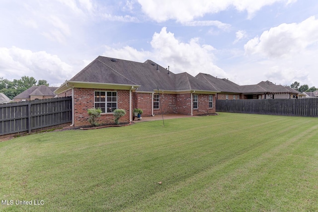 2634 Harvest Tree Dr, Southaven, MS 38672 - back of house with brick siding, a fenced backyard, a patio, and roof with shingles