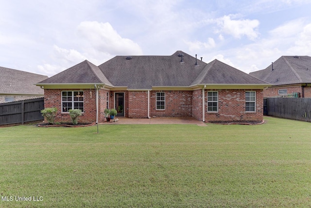 2634 Harvest Tree Dr, Southaven, MS 38672 - back of property with a fenced backyard, brick siding, a patio area, and a shingled roof