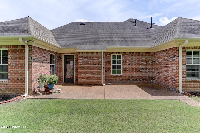 2634 Harvest Tree Dr, Southaven, MS 38672 - back of property with roof with shingles, brick siding, and a lawn