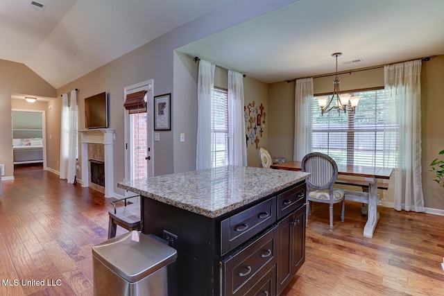 2634 Harvest Tree Dr, Southaven, MS 38672 - kitchen with a chandelier, plenty of natural light, light wood-style floors, vaulted ceiling, and pendant lighting
