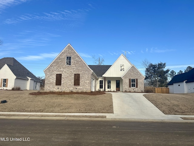 122 Grayson Way, Madison, MS 39110 - view of front of house with brick siding, an attached garage, board and batten siding, and concrete driveway