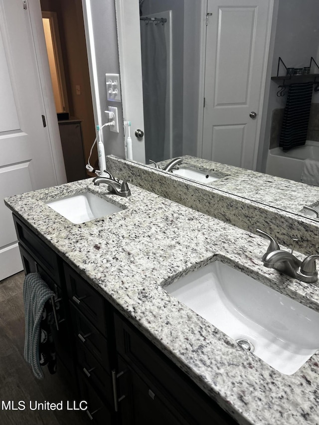 119 Whitetail Ln, Coldwater, MS 38618 - bathroom with double vanity, wood finished floors, and a shower with curtain