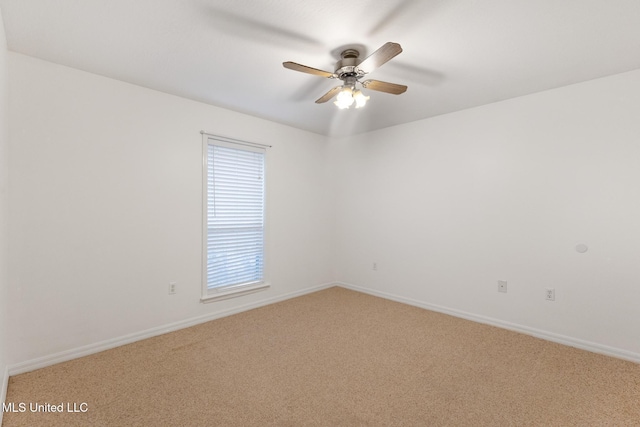 empty room with light carpet, baseboards, and a ceiling fan